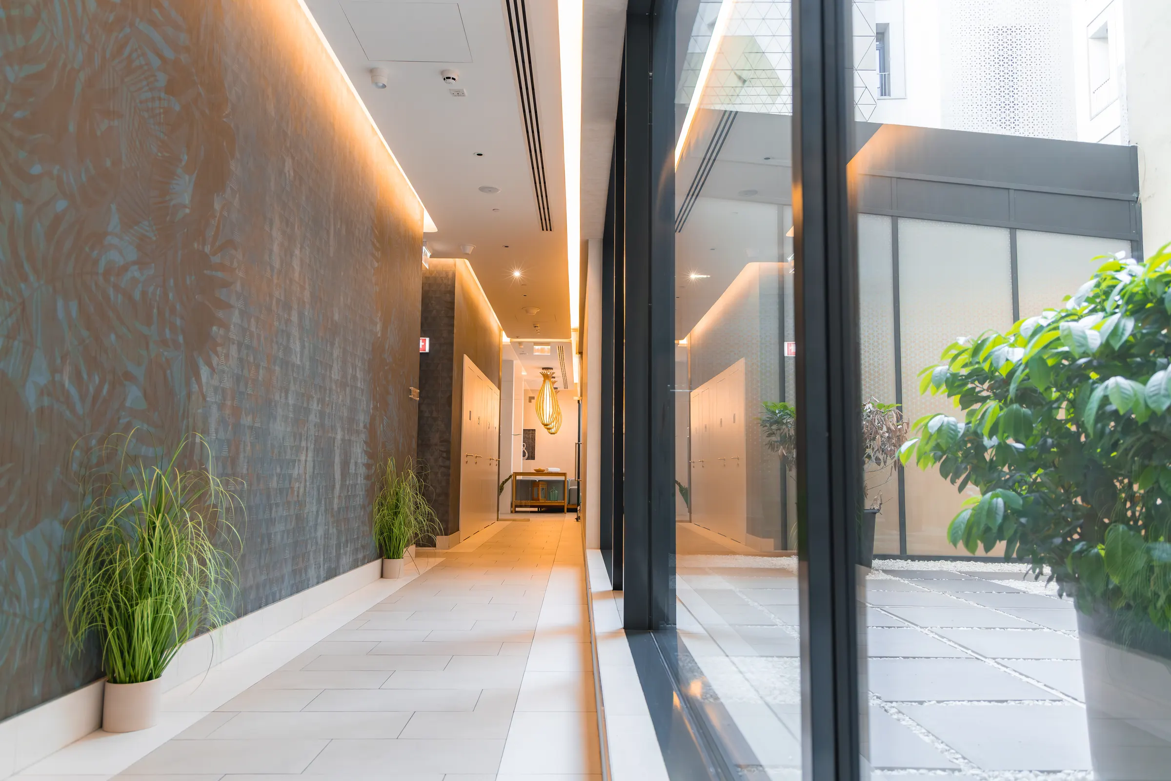 A bright apartment hallway with several doors